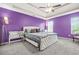 Spacious main bedroom with a ceiling fan, carpet, and a large bed at 11072 Pebble Ridge Dr, Hampton, GA 30228