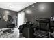 Salon featuring modern styling chairs, black walls, laminate floors and a shampoo bowl at 11072 Pebble Ridge Dr, Hampton, GA 30228