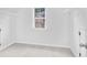 Bedroom featuring neutral carpet, white walls, and a window with natural light and a closet with wire shelving at 1433 Sand Way, Lawrenceville, GA 30045