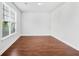 Bedroom with hardwood floors, a large window and crisp white walls at 1433 Sand Way, Lawrenceville, GA 30045