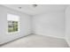 Empty bedroom with carpet and a window at 1433 Sand Way, Lawrenceville, GA 30045