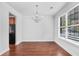 Dining space with hardwood floors, a chandelier, and a large window for natural light at 1433 Sand Way, Lawrenceville, GA 30045