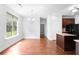 Dining area with wood floors adjacent to kitchen at 1433 Sand Way, Lawrenceville, GA 30045
