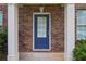Close-up of front door with glass panel and white trim columns around the brick entrance at 1433 Sand Way, Lawrenceville, GA 30045