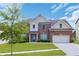 Charming two-story brick home featuring a well-manicured lawn, attached garage, and welcoming entrance at 1433 Sand Way, Lawrenceville, GA 30045