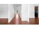 Bright hallway with wood flooring, white walls and multiple doors on either side at 1433 Sand Way, Lawrenceville, GA 30045