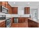 Kitchen featuring stainless-steel appliances and wood cabinets at 1433 Sand Way, Lawrenceville, GA 30045