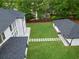 Lush backyard with a pathway connecting the main house to a detached structure; great outdoor space at 2709 Collins Hill Rd, Lawrenceville, GA 30043
