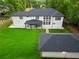 Expansive backyard featuring a large lawn, modern patio, and stylish detached structure at 2709 Collins Hill Rd, Lawrenceville, GA 30043