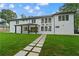 Expansive backyard with stone paver walkway leading to a modern home, perfect for entertaining at 2709 Collins Hill Rd, Lawrenceville, GA 30043