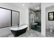 Luxury bathroom with a modern bathtub, shower, and marble floors at 2709 Collins Hill Rd, Lawrenceville, GA 30043