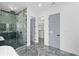Bathroom with marble tiling, walk-in shower, and doorway to a walk-in closet at 2709 Collins Hill Rd, Lawrenceville, GA 30043