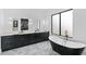 Modern bathroom featuring a freestanding tub, double vanity with black cabinets, and stylish marble flooring at 2709 Collins Hill Rd, Lawrenceville, GA 30043