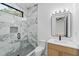 Elegant bathroom with a marble shower, modern vanity, and stylish fixtures at 2709 Collins Hill Rd, Lawrenceville, GA 30043