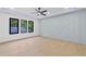 Bright bedroom with decorative wall, large windows, and a ceiling fan at 2709 Collins Hill Rd, Lawrenceville, GA 30043