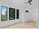 Bright bedroom featuring hardwood floors, modern black framed windows overlooking backyard at 2709 Collins Hill Rd, Lawrenceville, GA 30043