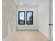 Sun-filled bedroom with accent wall, hardwood floors, and windows that offer a view of the neighborhood at 2709 Collins Hill Rd, Lawrenceville, GA 30043