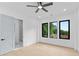 Light-filled bedroom features hardwood floors, a ceiling fan, and an en-suite bathroom at 2709 Collins Hill Rd, Lawrenceville, GA 30043