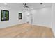 Bright and open bedroom with hardwood flooring, a ceiling fan, and multiple windows at 2709 Collins Hill Rd, Lawrenceville, GA 30043