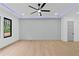 Open bedroom with a designer accent wall, ceiling fan and a large window at 2709 Collins Hill Rd, Lawrenceville, GA 30043