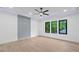 Modern bedroom with a ceiling fan, recessed lights, and three large windows with a view of trees at 2709 Collins Hill Rd, Lawrenceville, GA 30043
