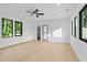 Spacious bedroom with a ceiling fan, hardwood floors, and modern black frame windows at 2709 Collins Hill Rd, Lawrenceville, GA 30043