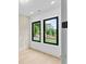 Bright bedroom with decorative wall, hardwood floors, and windows that look out onto a green landscape at 2709 Collins Hill Rd, Lawrenceville, GA 30043