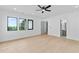 Spacious bedroom with hardwood flooring, large windows, ceiling fan, and ensuite bathroom at 2709 Collins Hill Rd, Lawrenceville, GA 30043