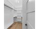 Neat walk-in closet with custom shelving and hardwood floors at 2709 Collins Hill Rd, Lawrenceville, GA 30043