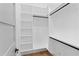 Walk-in closet featuring custom shelving and hardwood floors at 2709 Collins Hill Rd, Lawrenceville, GA 30043