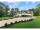 Modern home with a long driveway lined with shrubs leading to an attached two-car garage in a well-maintained yard at 2709 Collins Hill Rd, Lawrenceville, GA 30043