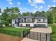 Stunning two-story home with modern design, lush lawn, gated entrance, and a spacious driveway to garage at 2709 Collins Hill Rd, Lawrenceville, GA 30043