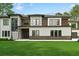 Stunning home showcasing a modern exterior with mixed materials and lush green lawn, perfect for upscale living at 2709 Collins Hill Rd, Lawrenceville, GA 30043