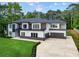 Striking two-story home with modern design, featuring a spacious driveway and well-maintained landscaping at 2709 Collins Hill Rd, Lawrenceville, GA 30043