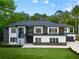 Modern two-story home with a contrasting color scheme, well-manicured lawn, and elegant front entrance at 2709 Collins Hill Rd, Lawrenceville, GA 30043