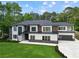 Stunning two-story home with modern design, lush lawn, and a spacious driveway leading to a two-car garage at 2709 Collins Hill Rd, Lawrenceville, GA 30043