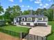 Elegant two-story home with a modern design, complemented by a gated entrance and landscaped front yard at 2709 Collins Hill Rd, Lawrenceville, GA 30043