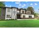 Modern home with a well-manicured lawn, a striking mix of materials on the facade, and stylish architectural details at 2709 Collins Hill Rd, Lawrenceville, GA 30043