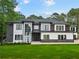 Modern two-story home with a contrasting color scheme, well-manicured lawn, and elegant front entrance at 2709 Collins Hill Rd, Lawrenceville, GA 30043