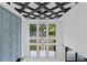 Stunning foyer with a decorative ceiling, modern chandelier, and wall of large windows at 2709 Collins Hill Rd, Lawrenceville, GA 30043