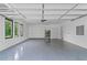 Oversized garage with epoxy flooring, built-in storage, and large windows to let in natural light at 2709 Collins Hill Rd, Lawrenceville, GA 30043
