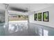 Large three car garage with epoxy flooring and windows to let in natural light at 2709 Collins Hill Rd, Lawrenceville, GA 30043