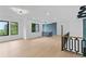 Bright hallway featuring modern lighting, hardwood floors, and stylish railing at 2709 Collins Hill Rd, Lawrenceville, GA 30043