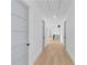 Hallway with hardwood flooring and doors leading to bedrooms at 2709 Collins Hill Rd, Lawrenceville, GA 30043