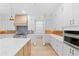 A kitchen boasts custom white cabinetry, stainless steel appliances, and a large island at 2709 Collins Hill Rd, Lawrenceville, GA 30043