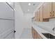 Well-lit laundry room with ample counter space and modern cabinets at 2709 Collins Hill Rd, Lawrenceville, GA 30043
