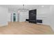 Open living room with modern fireplace, chandelier and beautiful flooring at 2709 Collins Hill Rd, Lawrenceville, GA 30043
