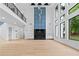 Bright and airy living room with soaring ceilings, a modern fireplace, floor-to-ceiling windows, and a second-story balcony at 2709 Collins Hill Rd, Lawrenceville, GA 30043