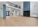 Spacious living room with tall ceilings, decorative wall paneling, and a modern fireplace at 2709 Collins Hill Rd, Lawrenceville, GA 30043