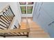 Modern staircase with wood stairs, black railings, and clerestory windows at 2709 Collins Hill Rd, Lawrenceville, GA 30043
